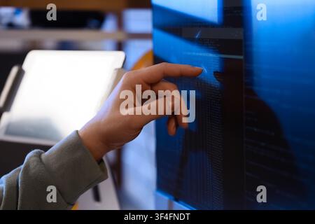 Female programmers hand testing code on computer in office at night, closeup Stock Photo