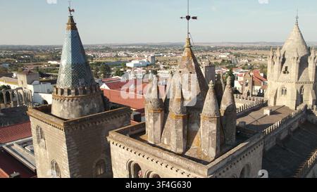 EVORA, PORTUGAL - MAY 15, 2024: A close aerial perspective of the ornate stone spires and tiled turrets of Evora Cathedral in Portugal. Stock Photo