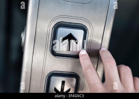 Elevator panel with illuminated up and down arrow buttons illustrating modern urban infrastructure and efficient vertical mobility Stock Photo