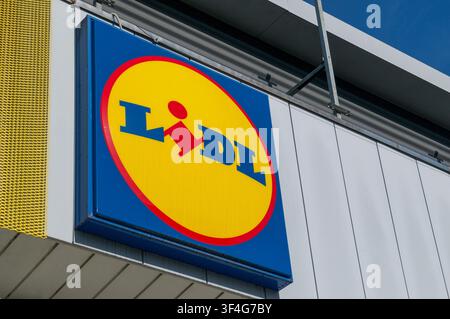Balerna, Ticino, Switzerland - 17th June 2026: Low angle close up view of the official blue and yellow Lidl supermarket logo sign on store facade Stock Photo
