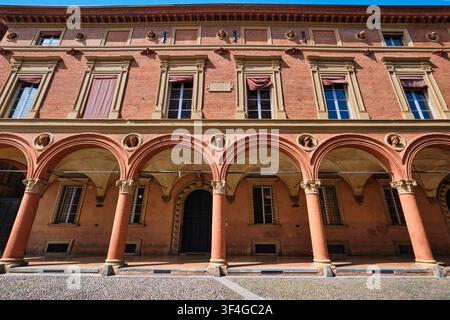 Bologna, Italy - May 2026: Symmetric low angle facade view of a Renaissance building with arcaded portico and portrait medallion details Stock Photo