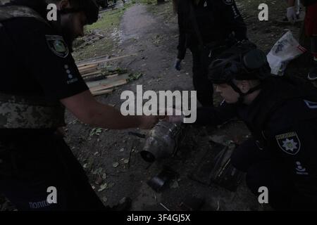Police officers examine a jet engine at the site where a Russian strike ...