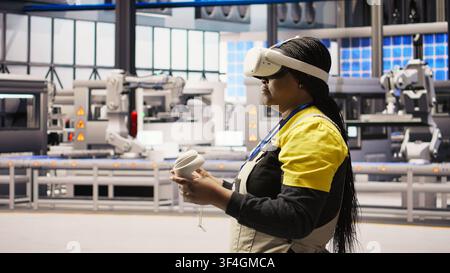 Photovoltaics smart factory specialist fixing damaged IoT sensors using VR tech. Mechanic in industry 4.0 solar panels plant using innovative virtual reality tech to find and fix errors, camera A Stock Photo