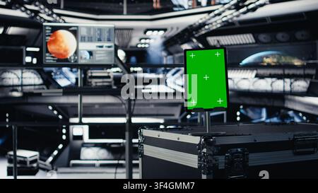 Chroma key device assisting orbit station astronauts in managing planetary observations. Isolated screen tablet in spaceship used for data input next to nearby display showing Mars mission analysis Stock Photo