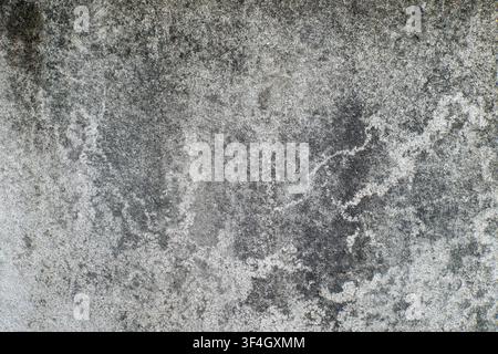 Weathered concrete wall texture featuring dark grunge patterns and rough surface details. Background overlay, digital design element, or distressed ar Stock Photo