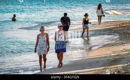 Tourists walking on the sand in the Cayman Islands Stock Photo