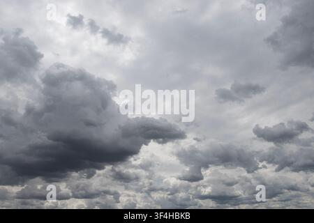 Layered dark storm clouds filling an overcast sky, creating a dramatic grey cloudscape and the sense of approaching rain Stock Photo