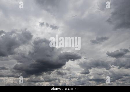 Layered dark storm clouds filling an overcast sky, creating a dramatic grey cloudscape and the sense of approaching rain Stock Photo