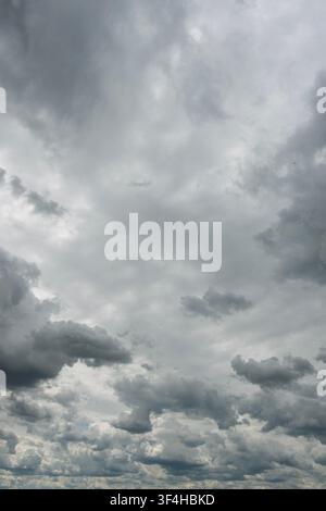 Layered dark storm clouds filling an overcast sky, creating a dramatic grey cloudscape and the sense of approaching rain Stock Photo