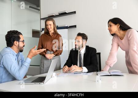 Multiethnic team members colleagues engaged in business discussion Stock Photo