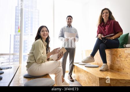 Portrait of smiling business team collaborating in modern corporate office Stock Photo