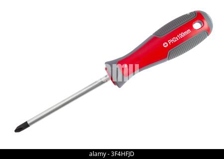 A red cross-head screwdriver isolated on a white background. Modern screwdriver close-up. Stock Photo
