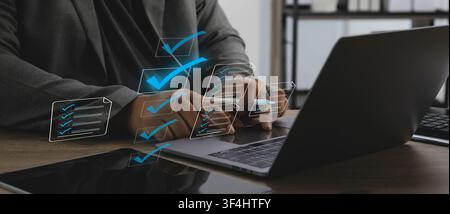 Business professional using laptop with digital checklist interface for document management, document online approval, file verification, document pap Stock Photo
