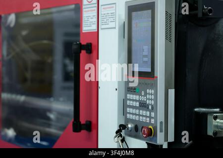 Injection molding machine with CNC control panel. Selective focus. Stock Photo