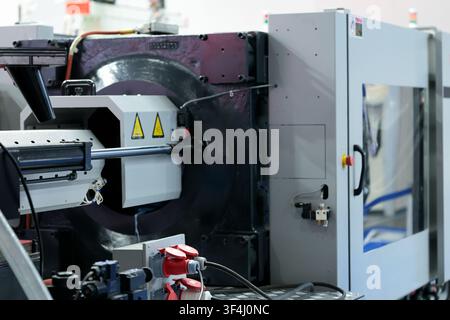 Plastic injection molding machine IMM close up. Selective focus. Stock Photo