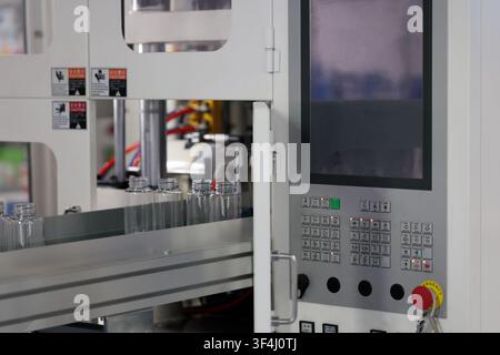 Automatic small plastic bottle making machine close up. Selective focus. Stock Photo