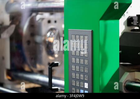 Close up of buttons on plastic molding machine control panel. Selective focus. Stock Photo