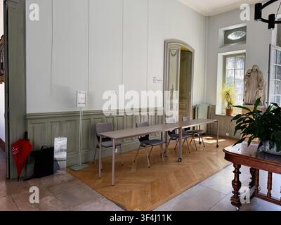 Paris, France - May 14, 2026: Elegant historic meeting room in Paris, France with a long table, chairs, statue and warm natural light. Stock Photo