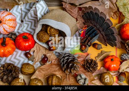 Autumn harvest arrangement featuring walnuts, acorns, pumpkins, pine cones, and fall leaves Stock Photo
