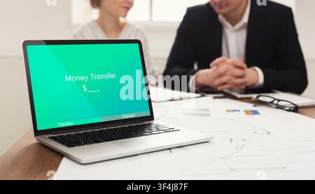 Money Transfer App Opened On Laptop In Bank Manager's Office Stock Photo