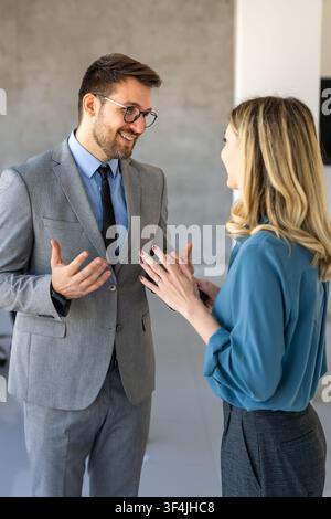 Professionals in a modern office environment discussing work-related matters Stock Photo