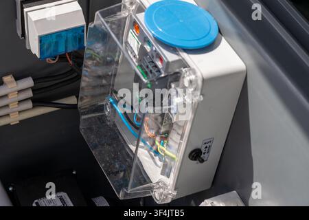 This detailed view showcases an industrial electrical enclosure with visible internal components, wiring, and a toggle switch for operation modes Stock Photo