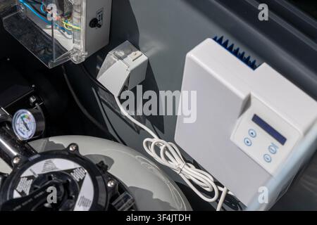 Detailed view of a pool's automated control system, pressure gauge, and filter housing, showcasing advanced water management technology Stock Photo