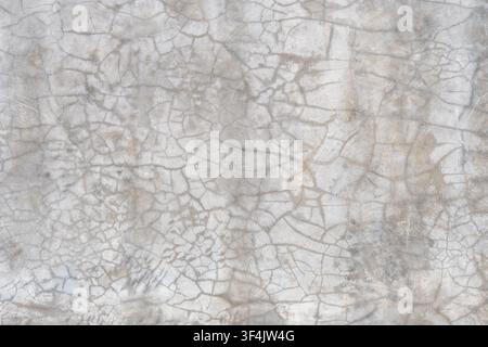 The texture of old, cracked cement. Fine cracks are often found in unpainted plaster walls or old concrete. Stock Photo