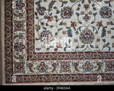 The carpet features detailed floral patterns and geometric shapes in rich colors, adding texture and warmth to the room. Stock Photo