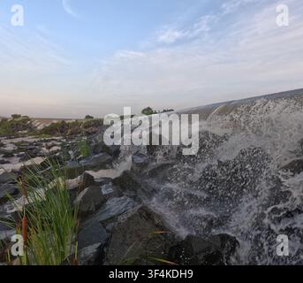 Scenic view of the artificial waterfall beneath 7 Makara Bridge on National Road 3 in Kandal Province, Cambodia. Stock Photo