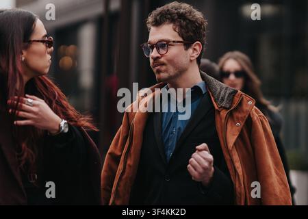Young professionals talking outside an office building during an urban business day Stock Photo