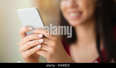 Closeup Image Of Unrecognizable Woman Using Modern Smartphone, Texting Or Browsing Internet Stock Photo