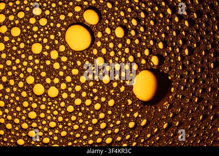 Macro view of liquid bubbles forming an abstract golden amber texture background Stock Photo