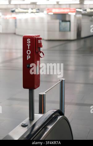 Emergency stop button on an escalator in a subway station illustrating the technical reliability of safety equipment. Stock Photo