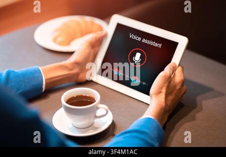 Man Holding Tablet Using Voice Assistant Sitting In Cafe, Cropped Stock Photo