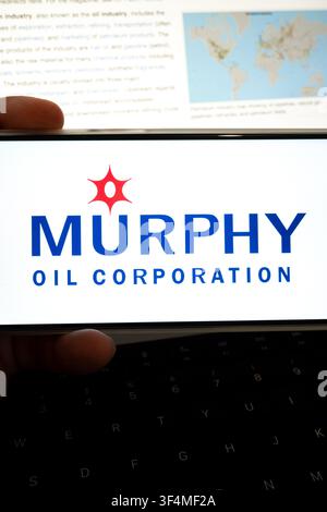 Mexico city, mexico, 07 28 2026, hand holding device showing murphy oil corporation logo, with petroleum industry information in background Stock Photo