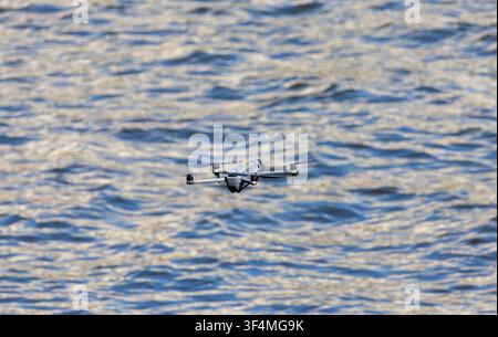 hobby drone flying over water Stock Photo