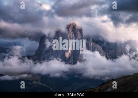 Dramatic mountain peak in clouds at sunset in Dolomites, Italy Stock Photo