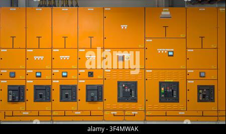Modern low voltage electrical switchgear and power distribution panels installed in a commercial industrial facility for energy management and electri Stock Photo