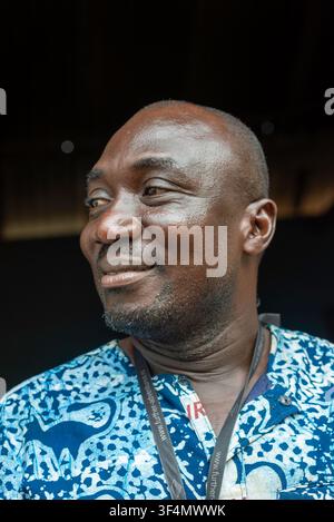 Man in patterned shirt smiles in profile, Ghana Stock Photo