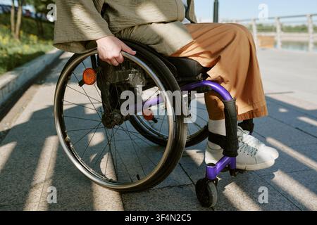 Woman with Disability Using Wheelchair Outdoors for Accessibility Stock Photo