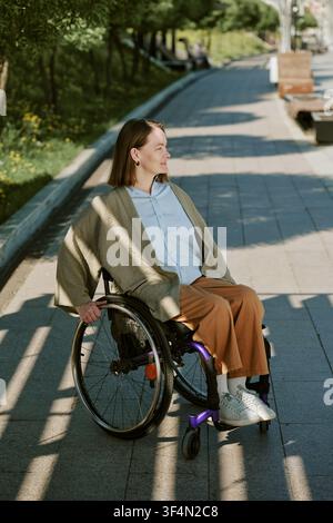 Young Adult Woman with Disability Outdoors for Inclusion Campaign Stock Photo