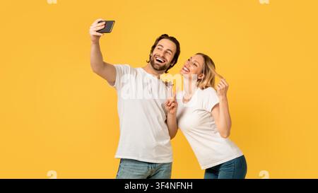 Happy Young Couple Taking Selfie At Home, Smiling Together, Joyful Moment Stock Photo