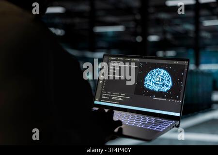 Close up of computer scientist using AI to implement security measures, fortifying data center defenses against cyber threats. Server hub worker uses deep learning to detect threats, defending systems Stock Photo