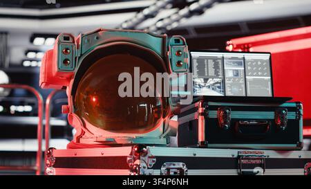 Critical error alert light flashing in spacecraft over space helmet next to laptop during journey to Mars. Malfunction hazard warning blinking over astronaut equipment during voyage to red planet Stock Photo