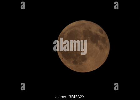 SWITZERLAND – July 29, 2026: A full blood moon rises behind the silhouette of a tree branch against a dark night sky in Switzerland during a lunar event on July 29, 2026. The reddish appearance of the moon creates a striking view of the celestial phenomenon. Photo by Yasin Kobulan / JNA Press. (Photo by Yasin Kobulan/JNA Press via Nexpher Images) Stock Photo