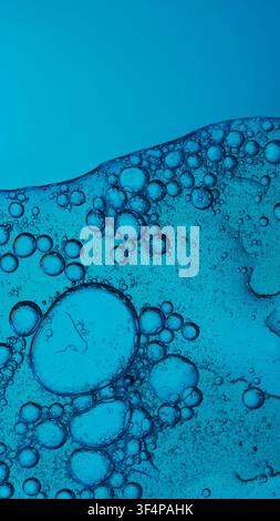 Blue liquid creating an abstract texture with various sizes of bubbles Stock Photo
