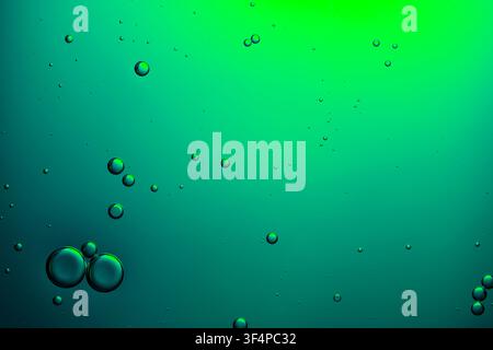 Bubbles creating an abstract pattern in green liquid, forming a vibrant background Stock Photo