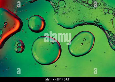 Abstract background showing merging oil drops and bubbles on a colorful liquid surface Stock Photo