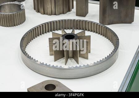 Technological gear hub close-up, industrial precision craftsmanship, intricate metallic details, clean well-lit setting, white minimal background, bri Stock Photo